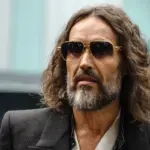 Trial Begins in London as Prosecutors Accuse Russell Brand of Operating as a "Serial Sexual Predator"